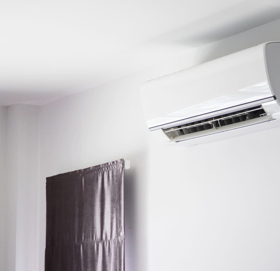 Wall-mounted air conditioning unit in a modern interior setting, emphasizing energy-efficient HVAC solutions for home comfort.