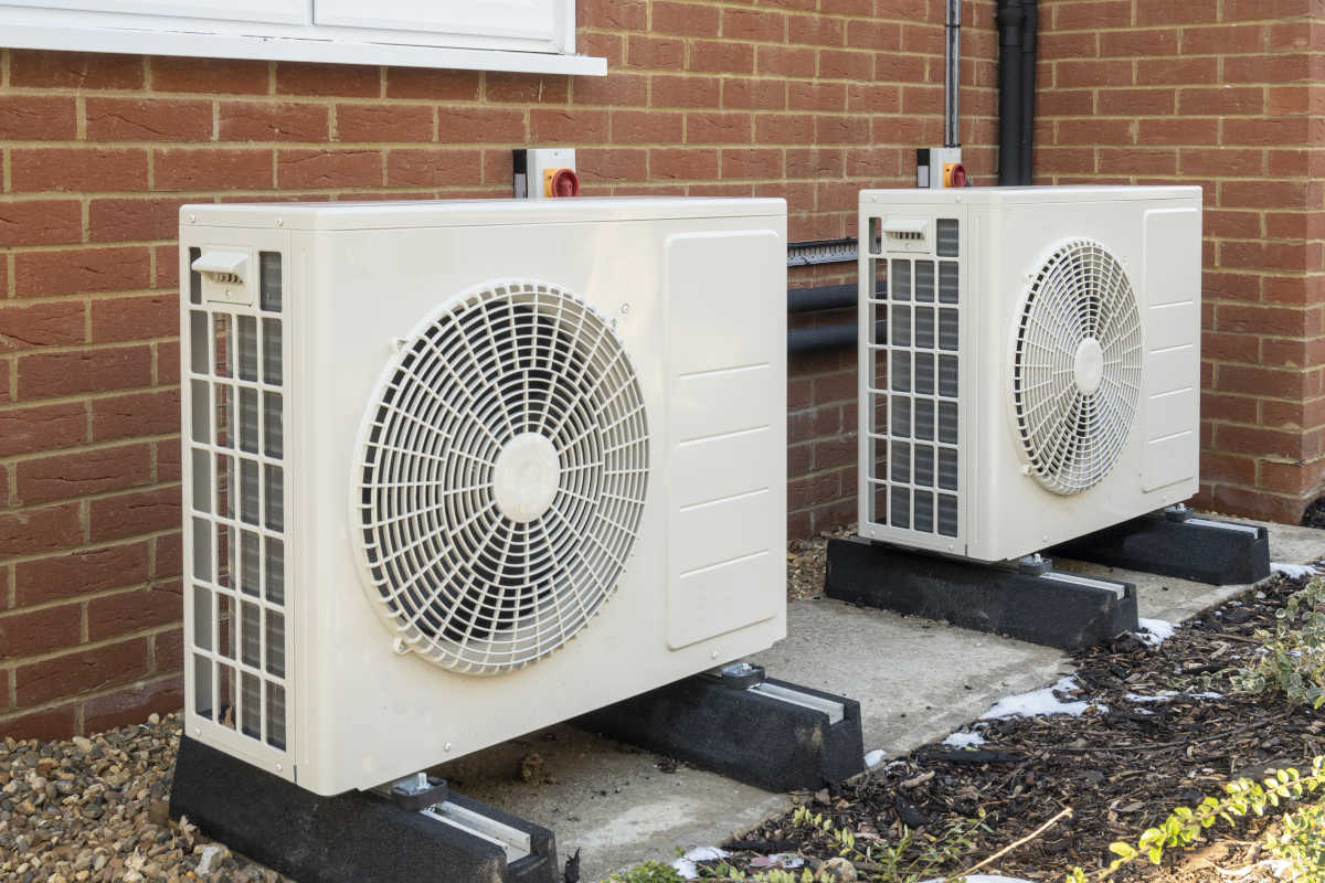 Heat pumps installed outside a residential building, demonstrating energy-efficient heating and cooling solutions for homes in Tempe, Arizona.