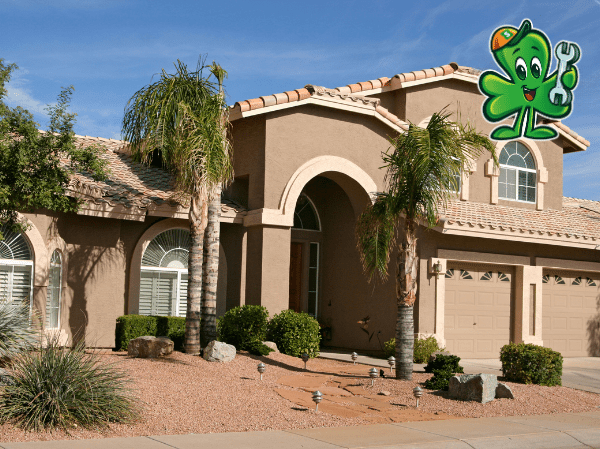 Residential home in Tempe, AZ, featuring palm trees and desert landscaping, with Shamrock Heating & Cooling logo emphasizing AC tune-up services for efficient air conditioning.