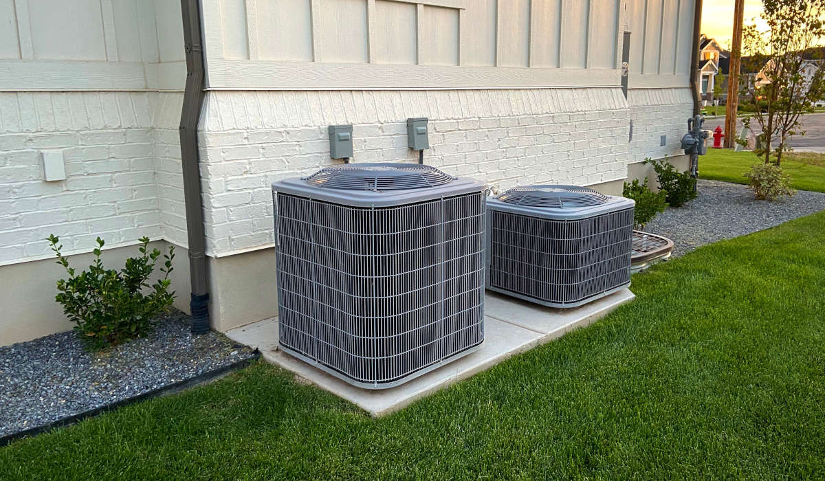 Air conditioning units installed outside a home, showcasing reliable cooling solutions for residential comfort in Tempe, AZ.